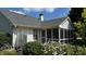 The backyard features a screened porch and lush flowers, perfect for enjoying the serene outdoor space at 2083 Kerns Ct, Carmel, IN 46280