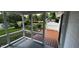 Relaxing screened porch with wood flooring and a view of the garden and a pond at 2083 Kerns Ct, Carmel, IN 46280