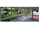 The screened-in porch offers views of a serene pond with a fountain, providing a perfect spot for relaxation and outdoor enjoyment at 2083 Kerns Ct, Carmel, IN 46280