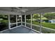 Beautiful screened-in porch with views of the serene backyard pond, perfect for relaxing and enjoying the outdoors at 2083 Kerns Ct, Carmel, IN 46280