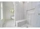 Bright bathroom featuring modern white marble, a frameless shower, and a luxurious soaker tub at 2130 Brookside Pkwy N Dr, Indianapolis, IN 46201