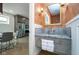 A modern powder room features a marble countertop and sink, and textured wallpaper at 2130 Brookside Pkwy N Dr, Indianapolis, IN 46201