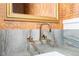 A modern powder room features a marble countertop, chrome faucet, and honey comb wallpaper at 2130 Brookside Pkwy N Dr, Indianapolis, IN 46201