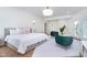 Light-filled bedroom includes a sitting area, French doors, and modern lighting at 2130 Brookside Pkwy N Dr, Indianapolis, IN 46201
