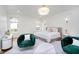 Bright bedroom boasts green velvet chairs, a white faux fur rug, and stylish gold accents at 2130 Brookside Pkwy N Dr, Indianapolis, IN 46201