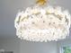 Striking floral chandelier features delicate glass petals and a warm, inviting glow at 2130 Brookside Pkwy N Dr, Indianapolis, IN 46201