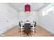 Cozy dining room with stylish gray chairs, a white table, and a unique overhead light at 2130 Brookside Pkwy N Dr, Indianapolis, IN 46201