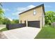 Modern home with a black garage door, driveway, and fenced yard at 2130 Brookside Pkwy N Dr, Indianapolis, IN 46201