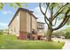 The modern home is complemented by lush greenery and a large shade tree at 2130 Brookside Pkwy N Dr, Indianapolis, IN 46201