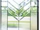 Close-up of a front door featuring decorative glass windows letting in natural light at 2130 Brookside Pkwy N Dr, Indianapolis, IN 46201