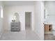 Bright hallway with gray accent cabinet leading to a bathroom with a sink and vanity at 2130 Brookside Pkwy N Dr, Indianapolis, IN 46201