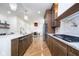 Modern kitchen with stainless steel appliances, a marble island, and hardwood flooring at 2130 Brookside Pkwy N Dr, Indianapolis, IN 46201