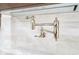 A modern pot filler is installed over the stove with marble backsplash for a sleek design at 2130 Brookside Pkwy N Dr, Indianapolis, IN 46201