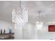 Bright living room with two crystal chandeliers, a sleek mantle, and crisp, white walls at 2130 Brookside Pkwy N Dr, Indianapolis, IN 46201