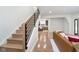 Inviting living room with an open staircase, hardwood floors, and modern decor elements at 2130 Brookside Pkwy N Dr, Indianapolis, IN 46201