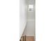 Staircase with modern lighting and a black iron handrail leading to a minimalist landing at 2130 Brookside Pkwy N Dr, Indianapolis, IN 46201