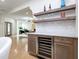 Wet bar area with floating shelves and marble countertops is convenient for entertaining at 2130 Brookside Pkwy N Dr, Indianapolis, IN 46201
