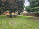 Spacious backyard featuring a trampoline and a fenced in yard at 2239 Chevelle Ct, Anderson, IN 46012