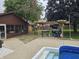 Backyard patio with a grill, a screened in sunroom, a pergola and an in-ground pool for outdoor entertaining at 2239 Chevelle Ct, Anderson, IN 46012