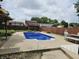 Spacious backyard with an in-ground swimming pool, patio furniture and an outbuilding with a privacy fence at 2239 Chevelle Ct, Anderson, IN 46012