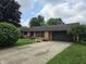 Charming single-story brick home with an attached garage and a long driveway at 2239 Chevelle Ct, Anderson, IN 46012