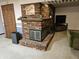 Cozy fireplace with brick surround and hearth, complemented by a wooden mantle and a comfortable sofa at 2239 Chevelle Ct, Anderson, IN 46012