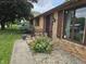 Close-up of a home entrance with decorative flowers, stone mulch, and attractive shutters at 2239 Chevelle Ct, Anderson, IN 46012