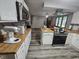 Bright kitchen featuring white cabinets, wood countertops, and stainless steel appliances at 2239 Chevelle Ct, Anderson, IN 46012