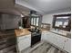 Bright kitchen with white cabinets, laminate countertops and stainless-steel appliances providing a functional cooking space at 2239 Chevelle Ct, Anderson, IN 46012
