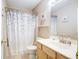 Bathroom with a light wood vanity, neutral walls, and a shower-tub combo with a floral curtain at 2359 Seattle Slew Dr, Indianapolis, IN 46234