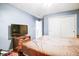 Cozy bedroom featuring a TV, a wooden dresser and a closet for ample storage at 2359 Seattle Slew Dr, Indianapolis, IN 46234