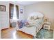 Comfortable bedroom featuring wood floors, a bright window and stylish decor at 2359 Seattle Slew Dr, Indianapolis, IN 46234