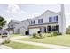 Charming two-story home featuring a well-maintained lawn, brick accents, and a cozy front porch at 2359 Seattle Slew Dr, Indianapolis, IN 46234