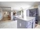 Open kitchen with an island, ample counter space, grey cabinetry, and flows seamlessly into the living area at 2359 Seattle Slew Dr, Indianapolis, IN 46234