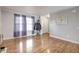 Inviting living room with gleaming hardwood floors, neutral paint, and large windows providing ample natural light at 2359 Seattle Slew Dr, Indianapolis, IN 46234