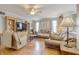 Comfortable living room with hardwood floors, built-in shelving, large windows, and comfortable seating at 2359 Seattle Slew Dr, Indianapolis, IN 46234