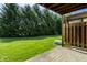 Lush backyard with a private patio, mature trees, and green grass at 2411 N Willow Way, Indianapolis, IN 46268