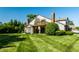 Charming home featuring a second-story deck and well-maintained lawn, perfect for outdoor living and relaxation at 2411 N Willow Way, Indianapolis, IN 46268