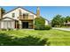 Backyard featuring manicured grass and the home's exterior with a deck and patio at 2411 N Willow Way, Indianapolis, IN 46268