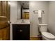 Cozy powder room features a modern vanity, dark cabinets, and a neutral color palette at 2411 N Willow Way, Indianapolis, IN 46268