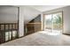 Second story bedroom featuring a sliding glass door to balcony and neutral carpet at 2411 N Willow Way, Indianapolis, IN 46268