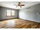 Bright bedroom with hardwood floors, neutral walls, and a ceiling fan for added comfort at 2411 N Willow Way, Indianapolis, IN 46268