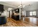 Open concept kitchen featuring black cabinets, wood countertops, and adjacent living area at 2411 N Willow Way, Indianapolis, IN 46268