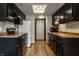 Well-lit kitchen with stainless steel appliances and ample storage in black cabinets at 2411 N Willow Way, Indianapolis, IN 46268
