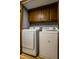 Convenient laundry room with a washer, dryer, and overhead cabinets for storage at 2411 N Willow Way, Indianapolis, IN 46268