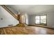 Bright living room with hardwood floors, staircase, and window, creating a welcoming space at 2411 N Willow Way, Indianapolis, IN 46268