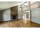 Spacious living room featuring a brick fireplace and sliding glass doors to the backyard at 2411 N Willow Way, Indianapolis, IN 46268