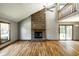 Bright living room features a fireplace, hardwood floors, and sliding door, providing access to outdoor at 2411 N Willow Way, Indianapolis, IN 46268