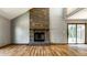 Living room features a brick fireplace, hardwood floors, and a sliding door, creating a cozy space at 2411 N Willow Way, Indianapolis, IN 46268