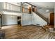 Bright open-concept living room featuring wood floors, staircase, and abundant natural light at 2411 N Willow Way, Indianapolis, IN 46268